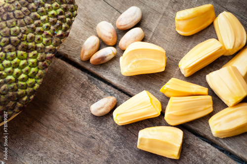 bright yellow pieses of jackfruit on wooden background