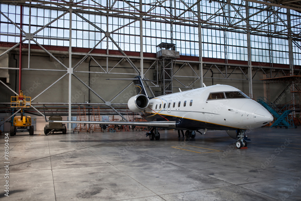 Business jet airplane stays in hangar. Business jet airplane stays in hangar.