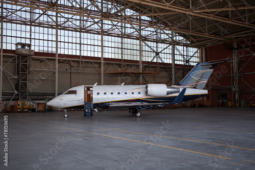 Business jet airplane stays in hangar..