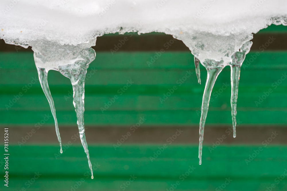 two group of icicles on the green wall background two group of icicles on the green wall background