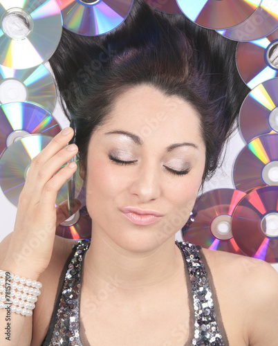 A young girl with DVDs record lay on the ground photo