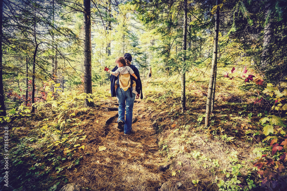 Mother Hiking with Baby in a Forest - Retro Filtered Mother Hiking with Baby in a Forest - Retro Filtered