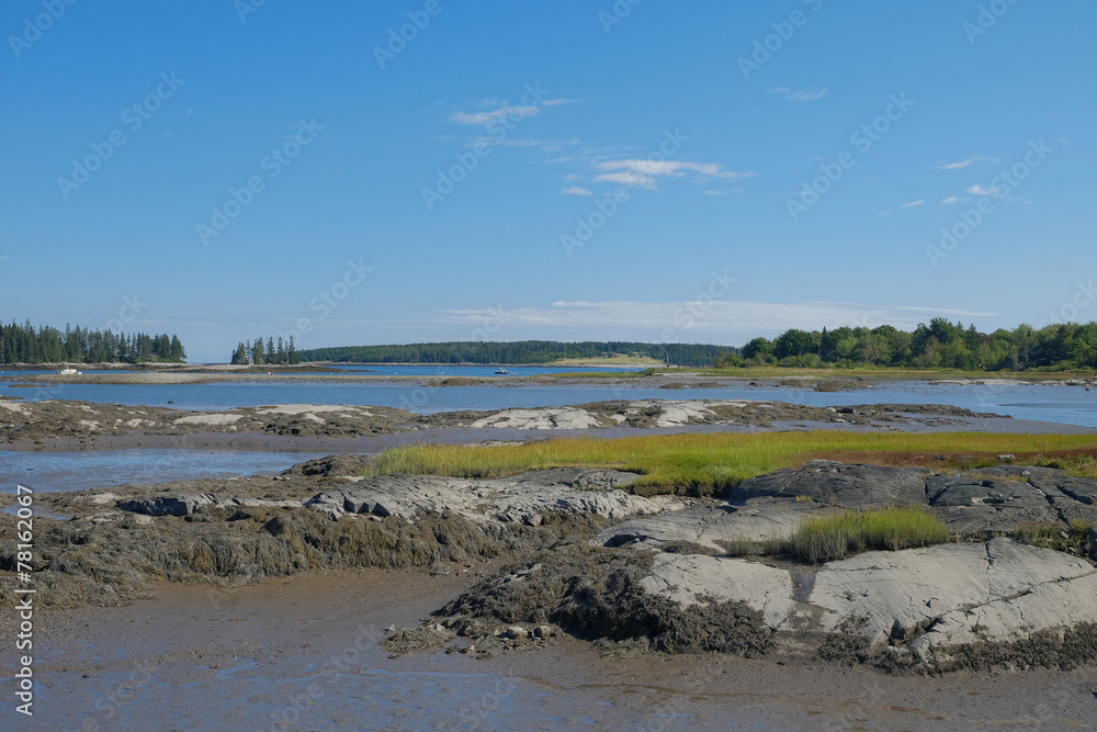 A secluded small bay and estuary at low tide showing the large g