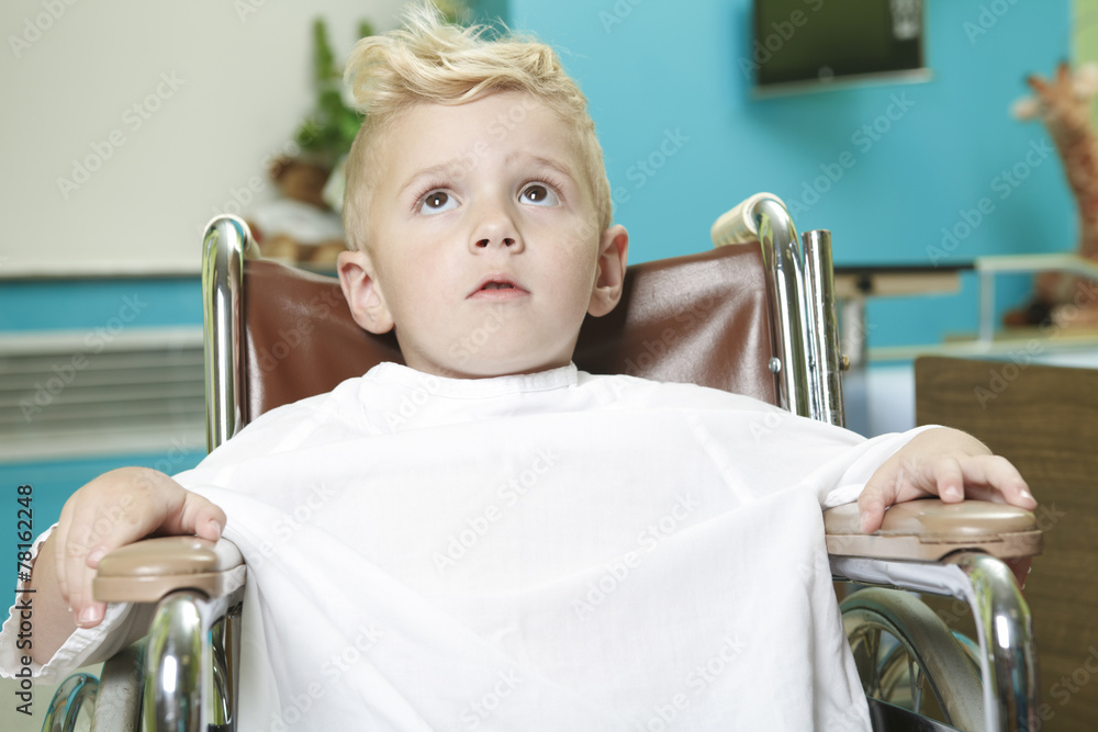 An adorable little boy in the wheelchair at the hospital An adorable little boy in the wheelchair at the hospital