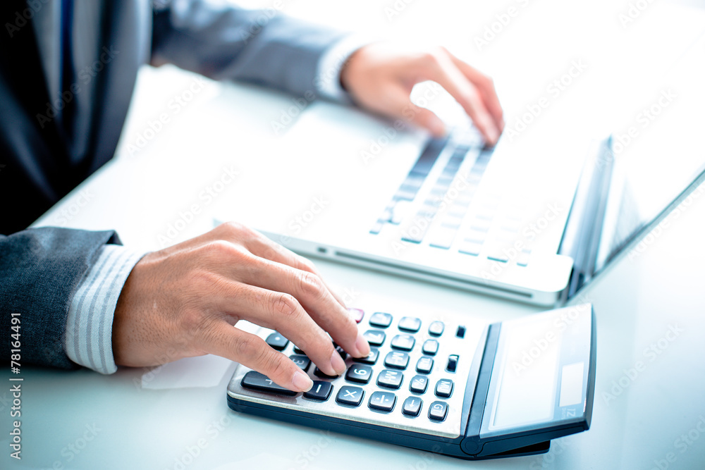 Closeup of businessman hands typing on laptop computer Closeup of businessman hands typing on laptop computer