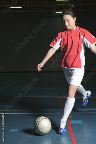 A female soccer player in a stadium © Louis-Photo