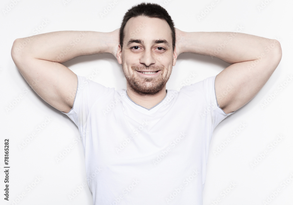 A relax man over a studio white background A relax man over a studio white background