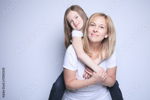 A mother with is daughter over gray background