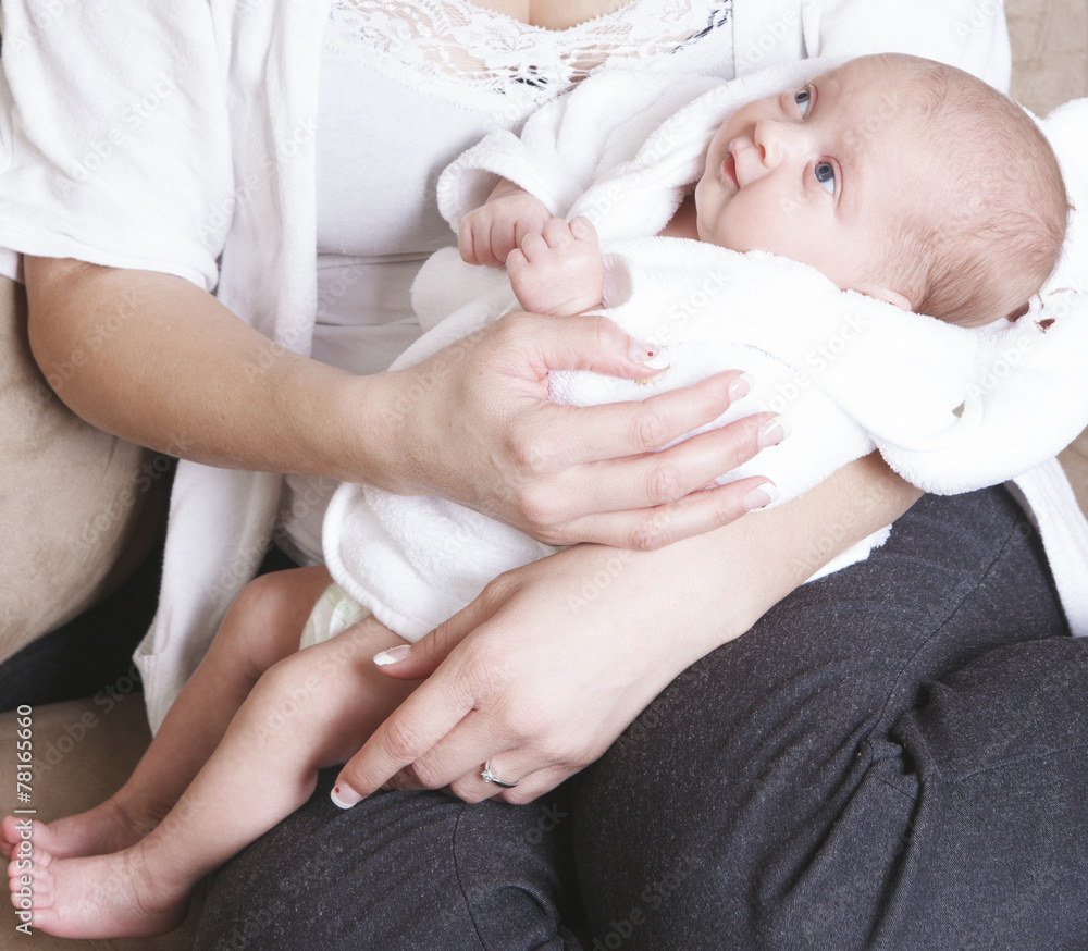 A mother with new baby at home on the sofa A mother with new baby at home on the sofa