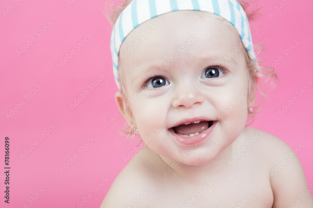 A happy baby girl isolated on pink background A happy baby girl isolated on pink background