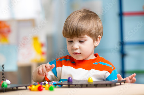 kid playing with educationa...