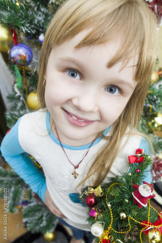 Portrait of a smiling girl on background of Christmas trees