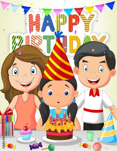 Happy girl blowing birthday candles with his family