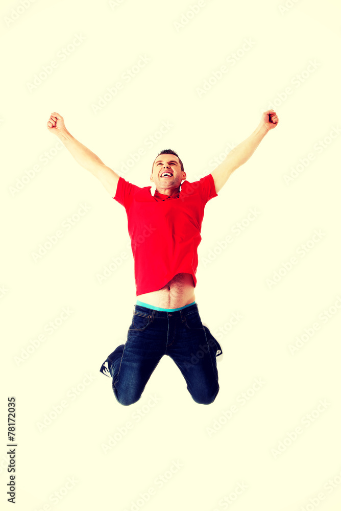 Young casual man jumping.