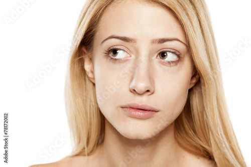 portrait of concerned young blonde without make up