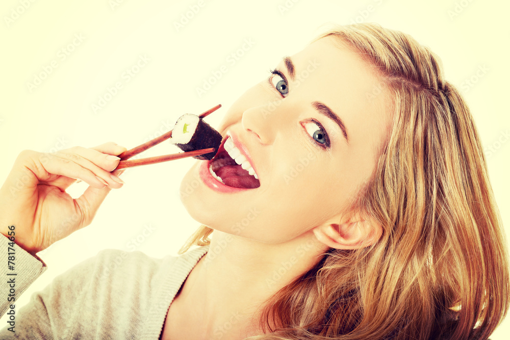 Woman eating sushi