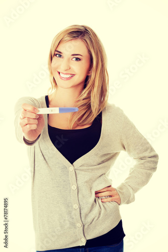 Happy woman with pregnancy test