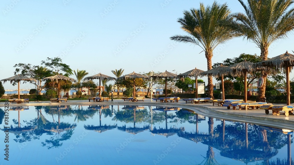 Swimming pool with palm trees in resort at morning 4k Swimming pool with palm trees in resort at morning 4k