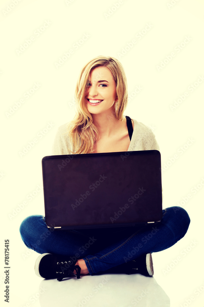 Smiling woman using a laptop Smiling woman using a laptop
