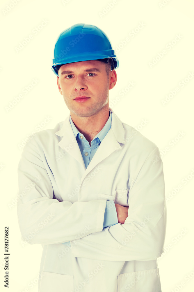 Man in a lab coat and helmet