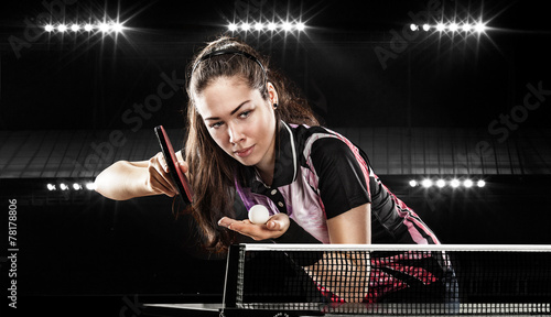 Young pretty sporty girl playing table tennis