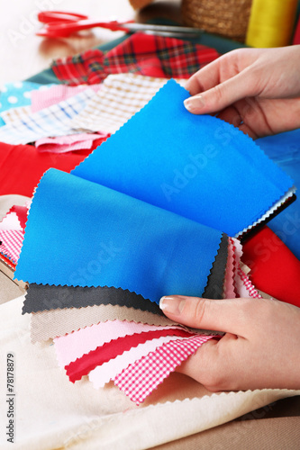Colorful fabric samples in female hands