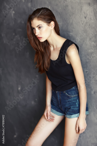 fashion young woman on grunge wall background