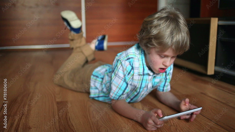 Child using tablet pc.Teenager boy using touch pad . Child using tablet pc.Teenager boy using touch pad .