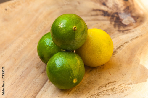 Fresh limes on wooden table