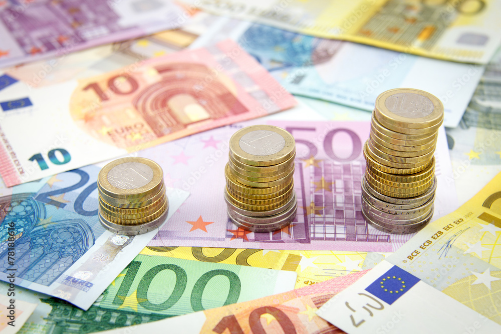 Increasing stacks of euro coins on euro banknotes Increasing stacks of euro coins on euro banknotes