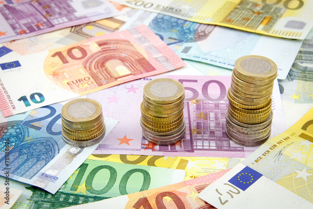 Increasing stacks of euro coins on euro banknotes Increasing stacks of euro coins on euro banknotes