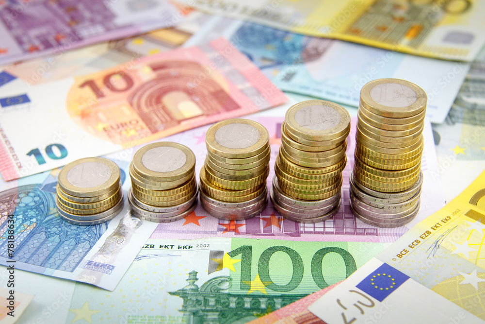 Increasing stacks of euro coins on euro banknotes Increasing stacks of euro coins on euro banknotes