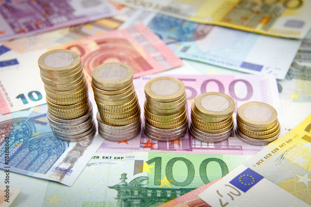 Decreasing stacks of euro coins on euro banknotes Decreasing stacks of euro coins on euro banknotes