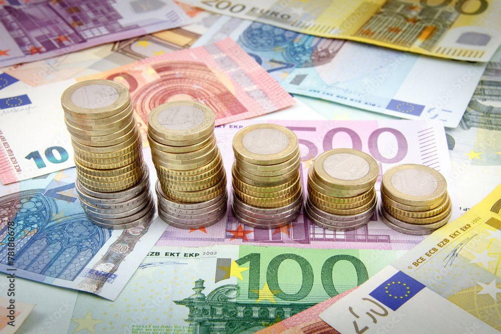 Decreasing stacks of euro coins on euro banknotes Decreasing stacks of euro coins on euro banknotes