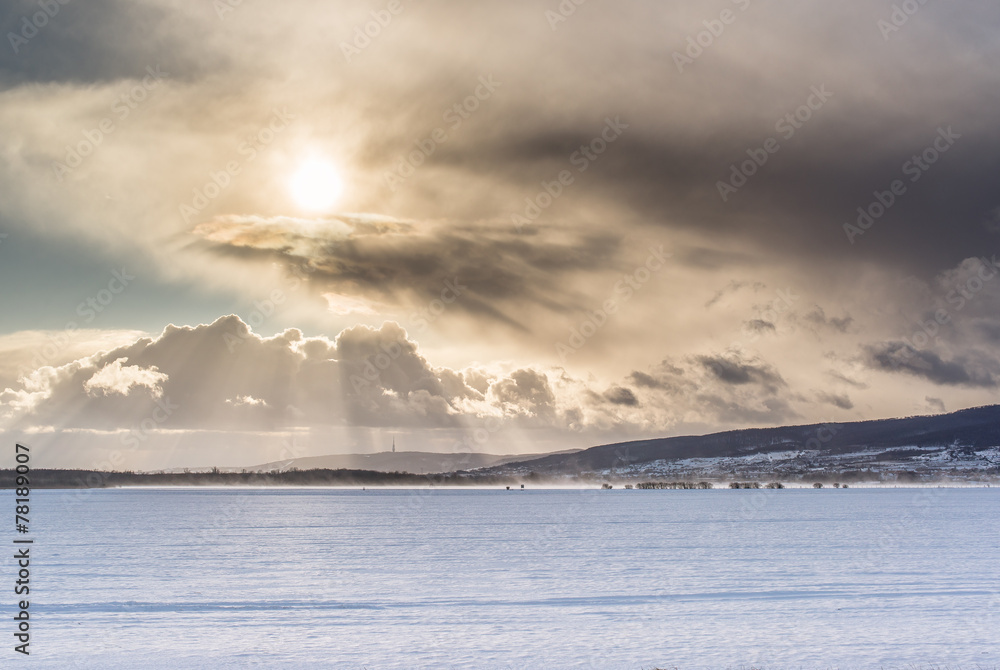 winter landscape with sun and clouds