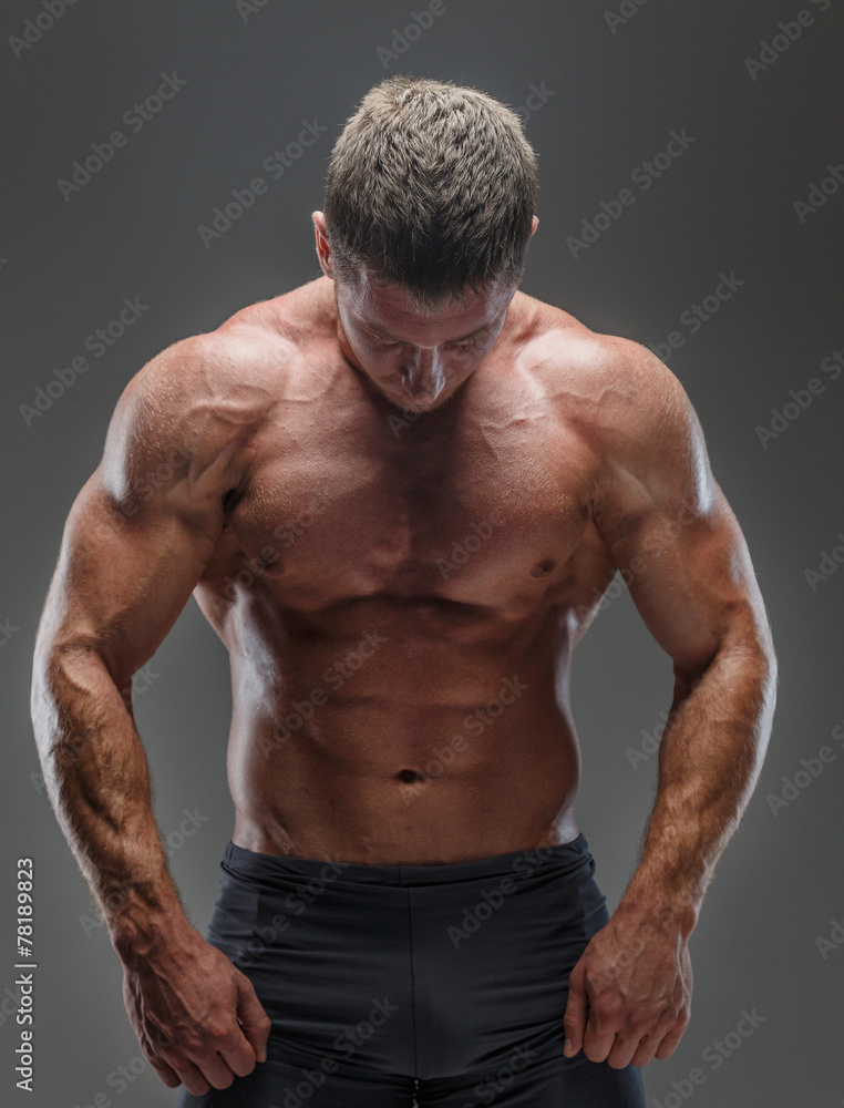 Muscular male showing his muscular body Muscular male showing his muscular body