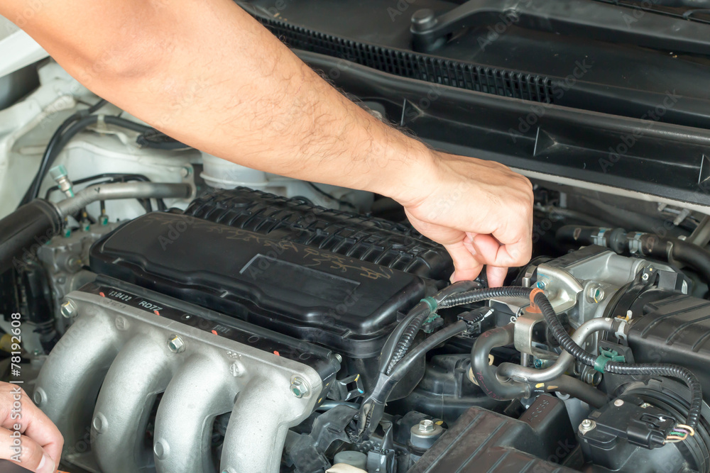 Technician checking car engine Technician checking car engine
