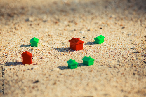 Small plastic houses on the beach