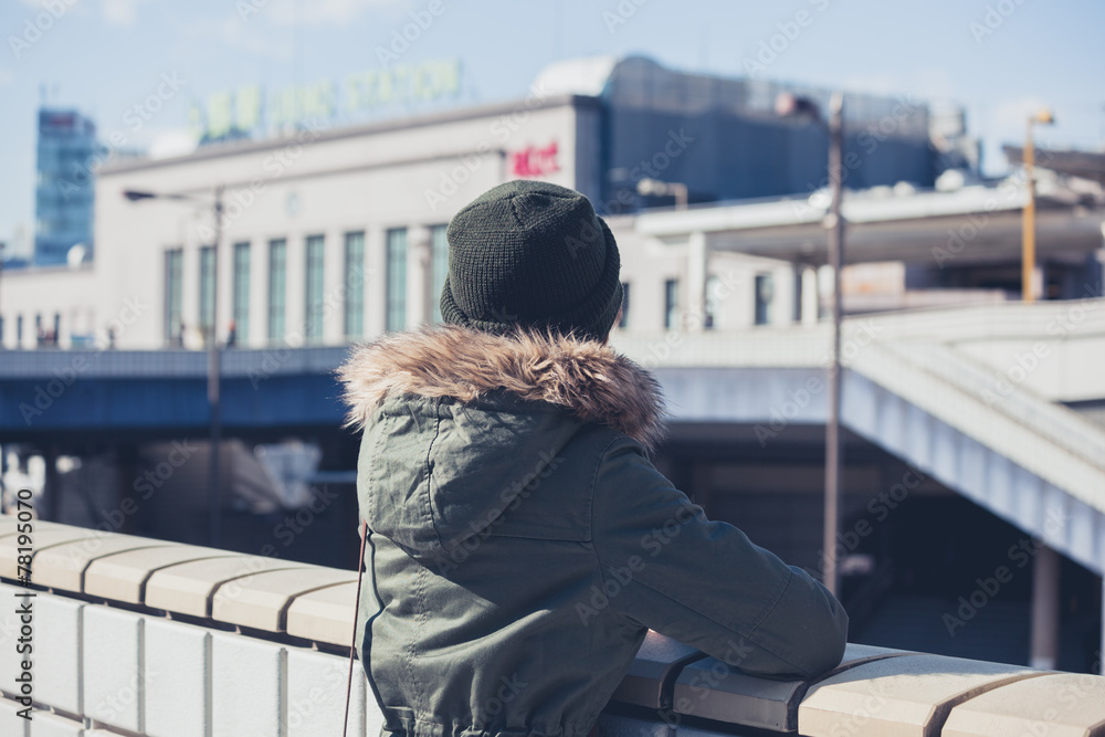 Fototapeta premium Woman looking at station in winter