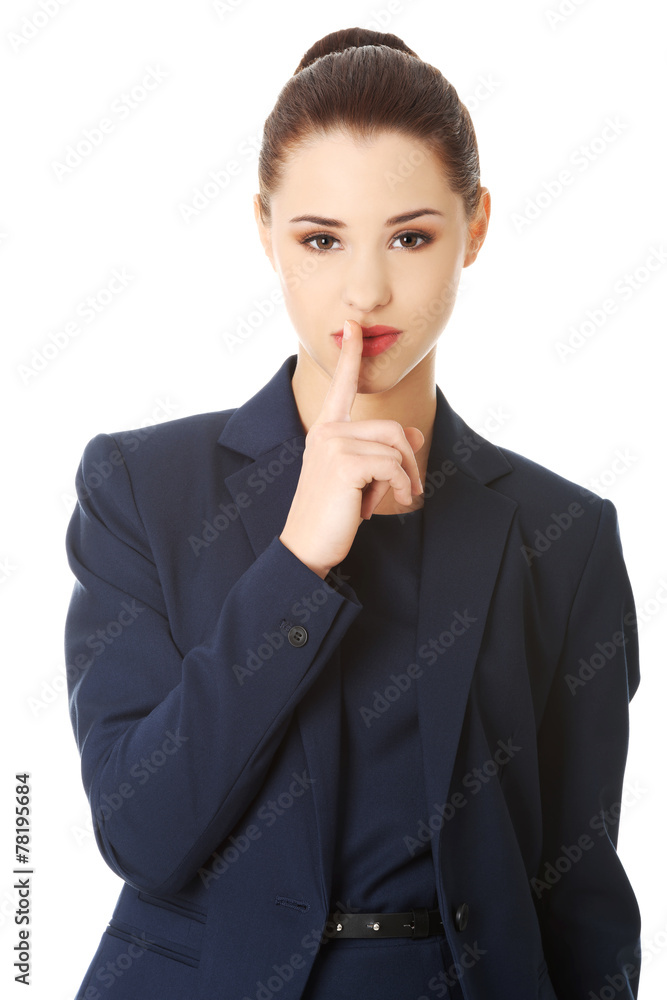 Businesswoman with finger on her lips Businesswoman with finger on her lips