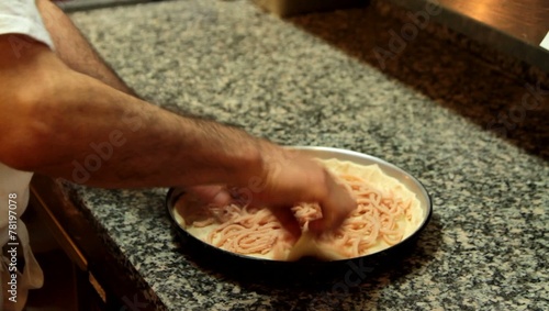 Pizza chef is making deep pan pizza