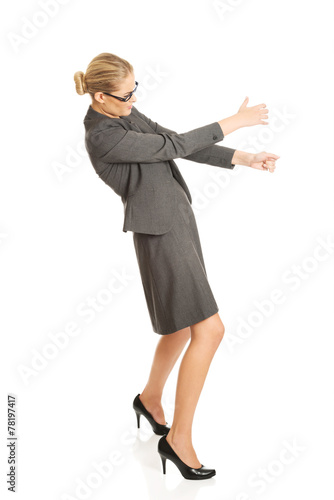 Businesswoman pulling a stick