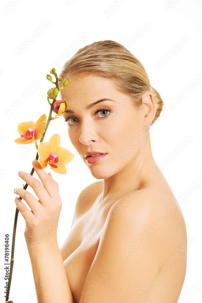 Naklejka premium Beautiful spa woman with orange orchid