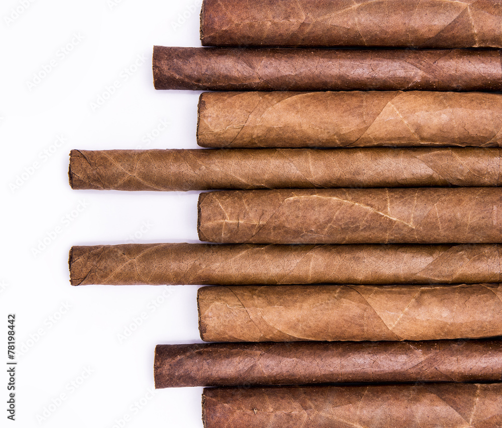 Cigars in a row with space for text. Close-up background Cigars in a row with space for text. Close-up background