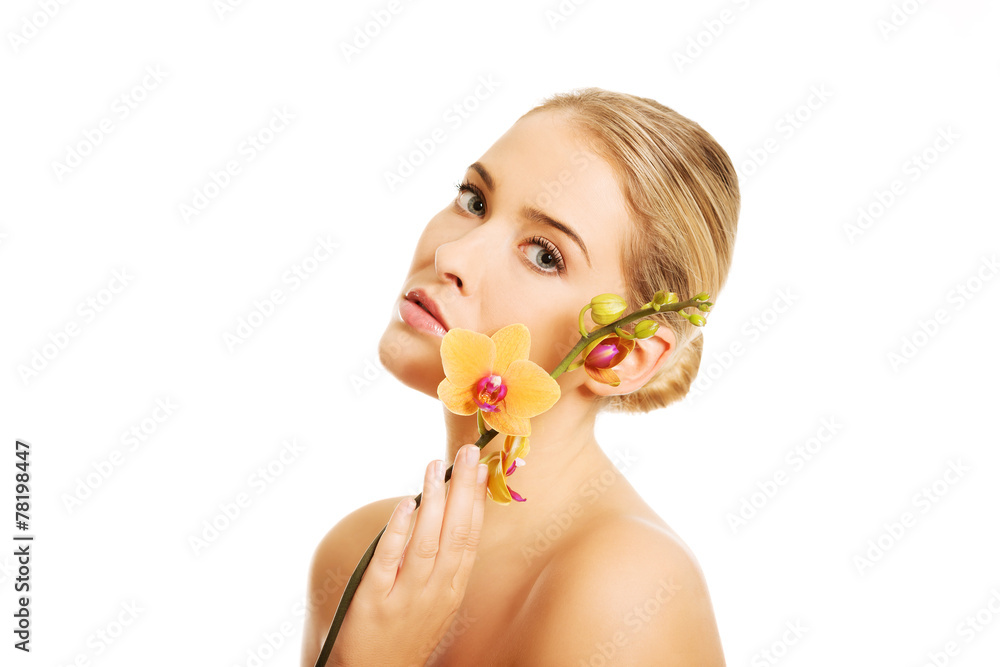 Naklejka premium Beautiful spa woman with orange orchid