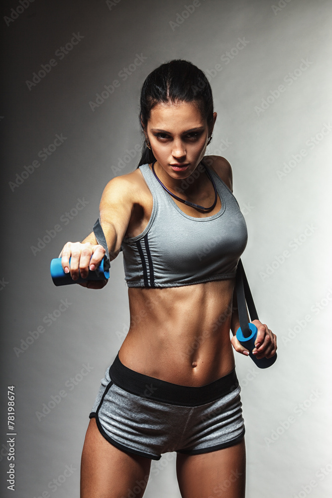 woman exercising with rubber tape - obrazy, fototapety, plakaty 