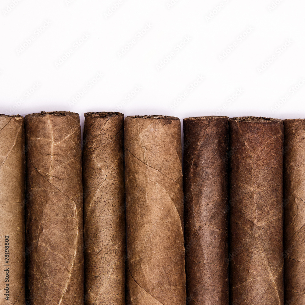 Cigars in a row with space for text. Close-up background Cigars in a row with space for text. Close-up background