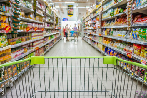 Shopping with shopping cart in snack department of supermarket