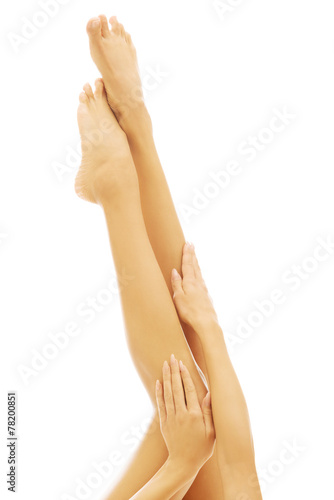 Woman hands touching woman s legs
