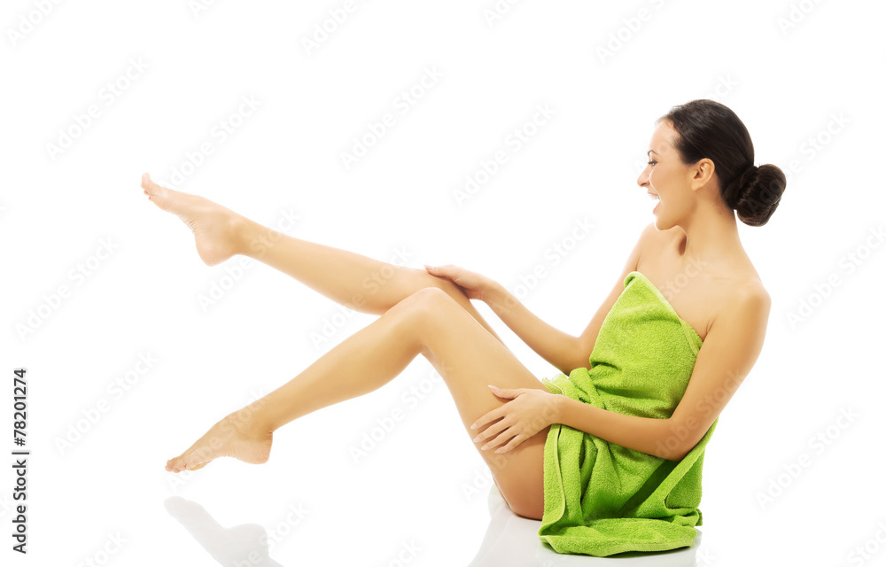 Side view woman wrapped in towel with legs up Side view woman wrapped in towel with legs up